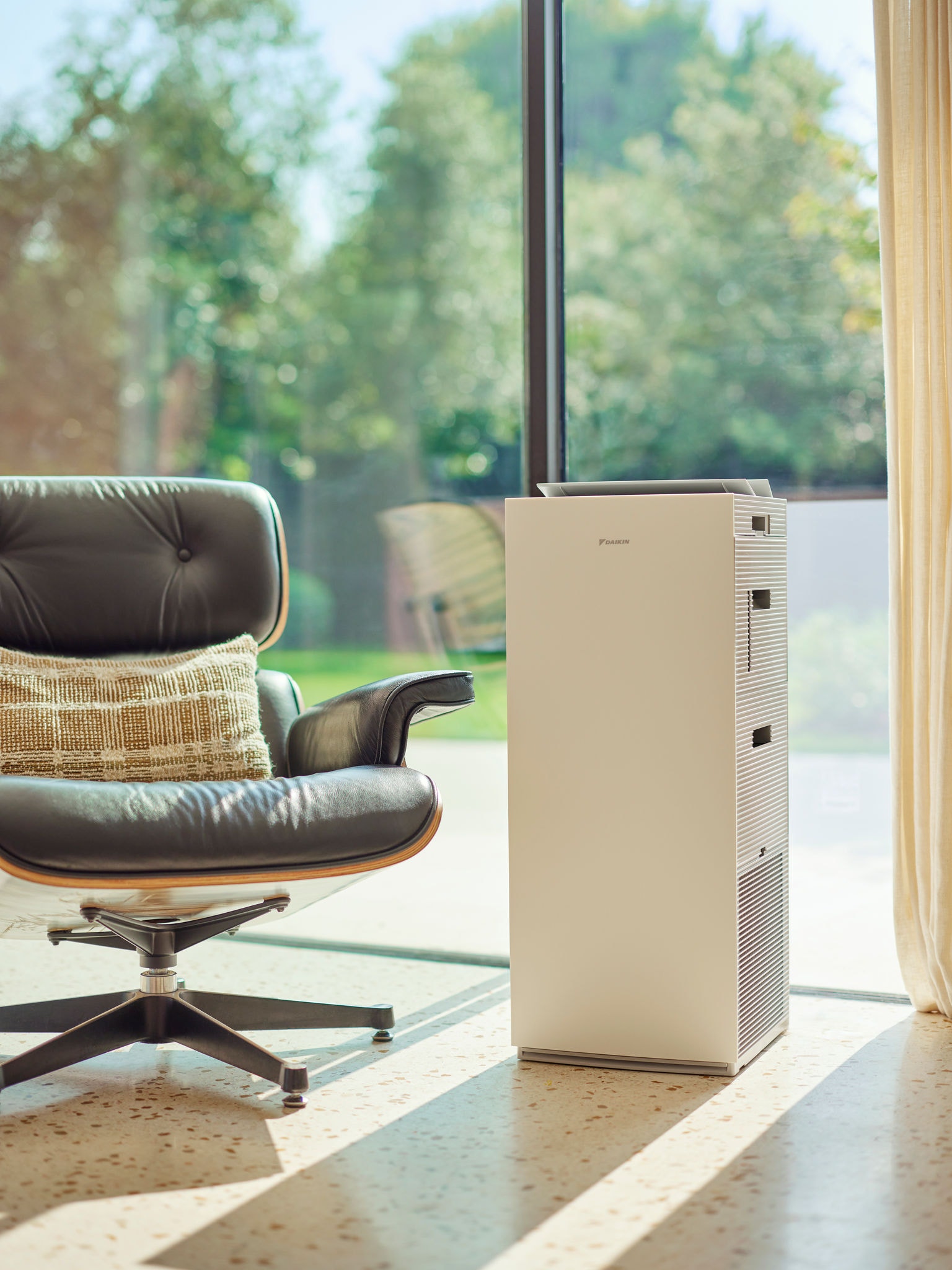 Couple with kid relaxing in bedroom enjoying clean air with air purifier