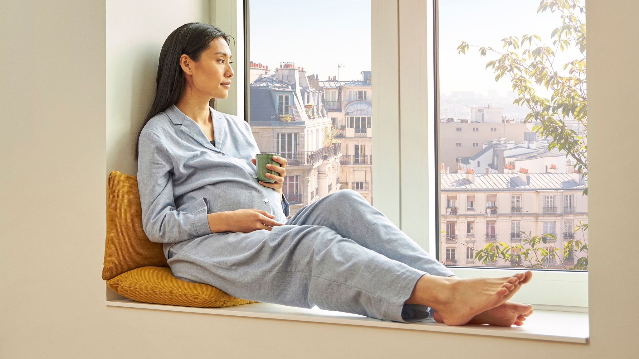Pregnant woman sitting in the windows  